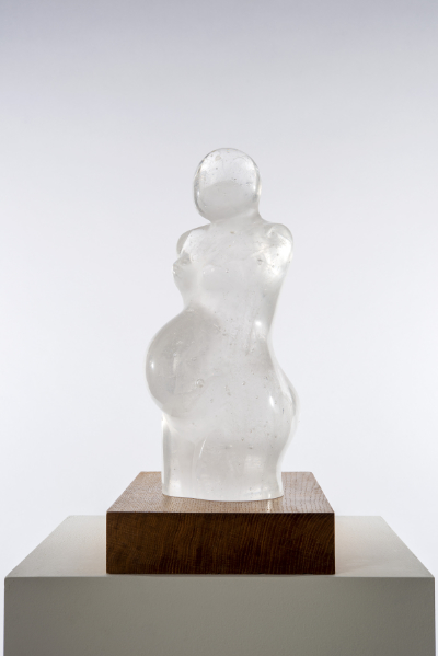 A cast glass sculpture of the female form in clear glass.