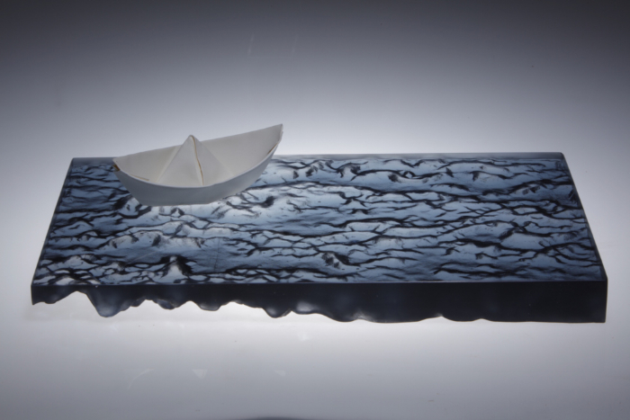 Reflection is a sculpture made from cast glass with a porcelain boat