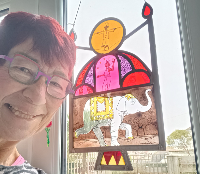 Susan Purser Hope with her gift of a stained glass panel featuring a circus theme