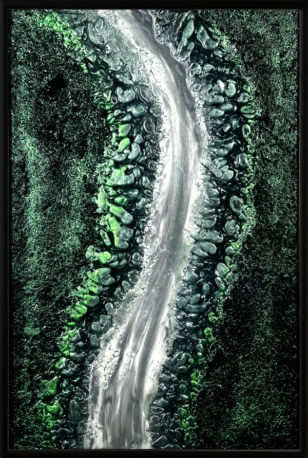 Glass arti piece 'Flowing Nature' uses lavacoaqting and is green and black with a streak of white and grey flowing down the centre of the design.