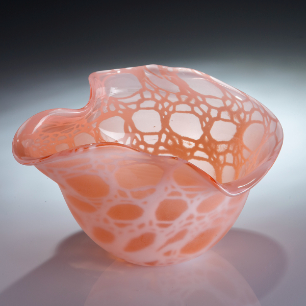 Salmon pink glass vessel featuring knitted design by Emmy Palmer.