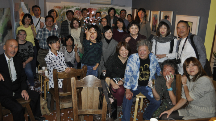 A large group of Japanese glassmakers with Sarah Brown at the opening party of the Naked Craft Project collaboration between Japan and the UK in 2015.
