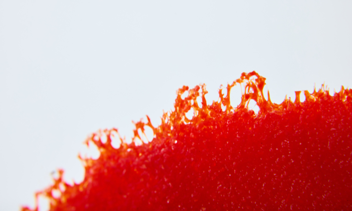 Detail of red pate de verre glass bowl sculpture called Crushed and Boiled.