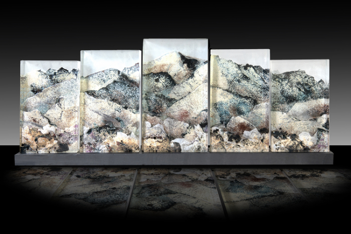 A 5-panel cast glass piece of Snowden by Kate Pasvol with the mountain top spreading across the five rectangular panels.