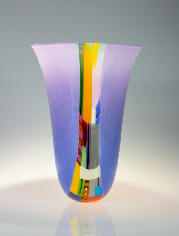 'Source Bellflower' glass vessel features a strip of bright yellow and other colours down one side against a backdrop of purple.