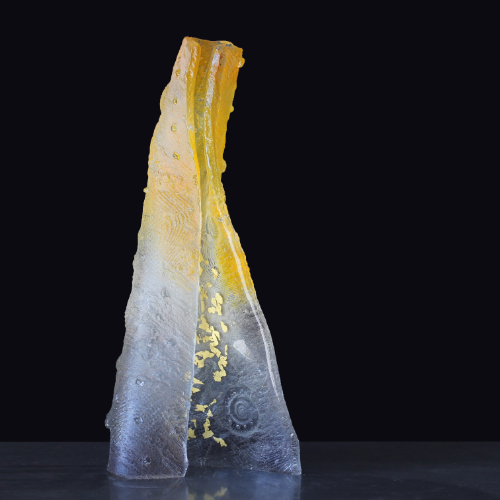 A vertical sand-cast glass sculpture with gold foil fused into it, distorted by hand-manipulation outside the kiln during the firing process.