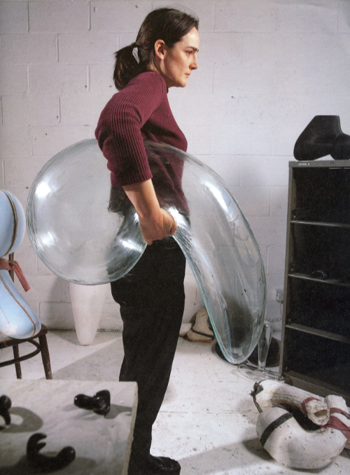 Emma Woffenden holding large clear glass floppy balloon shape under her arm. 