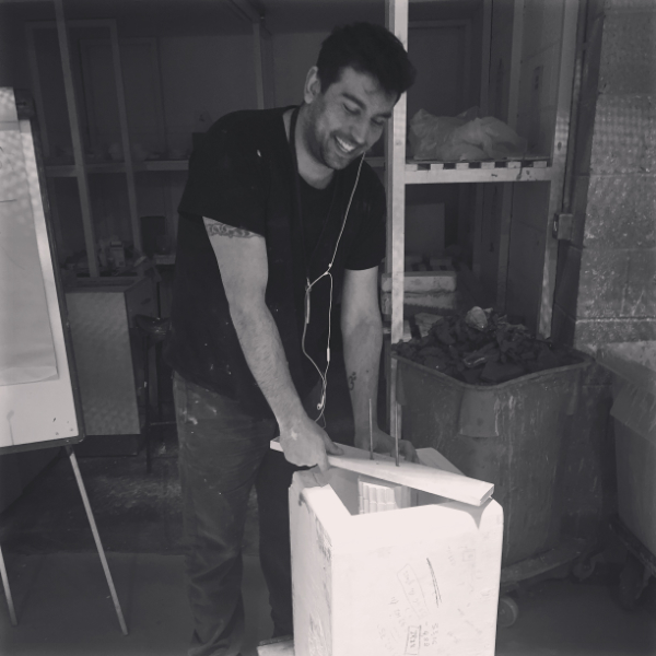 Antonis Koutouzis in the studio working on mould preparation for glass casting.