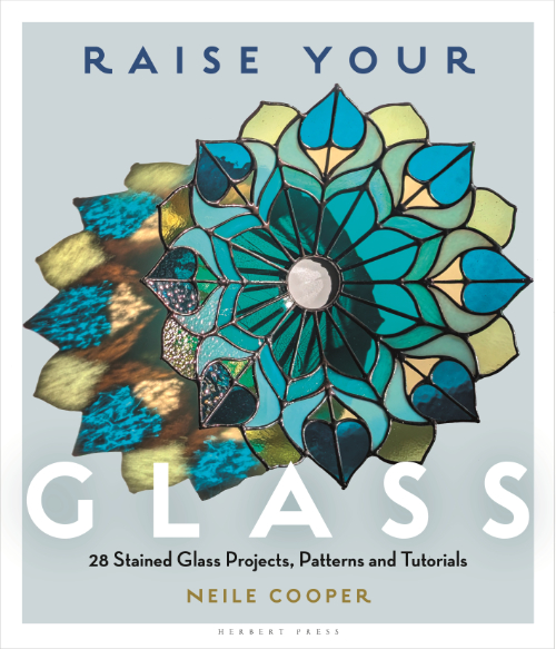 Cover image of Raise Your Glass book featuring stained glass peacock style dish in turquoise and greens.
