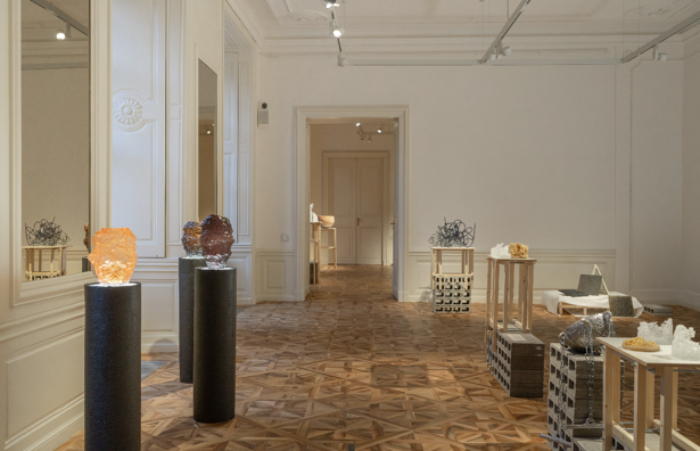 A view across a large room featuring an exhibition of different pieces of glass art