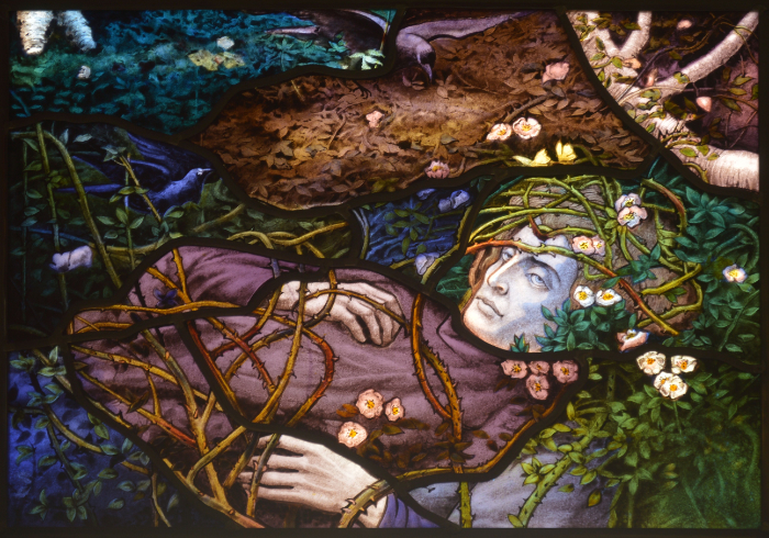 Detailed stained glass panel featuring a man lying in a woodland covered in branches and small flowers - image based on a painting by E. R. Hughes.