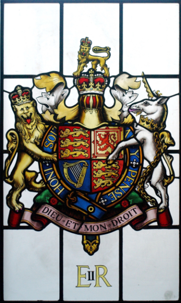 A stained glass coat of arms painted by Petri Anderson for Queen Elizabeth II and Price Philip at their Sandringham Estate. Featuring a shield in the centre plus lion and unicorn either side.