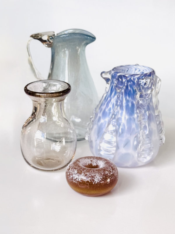 Four blown glass vessels by Amber Hahn in pastel shades.