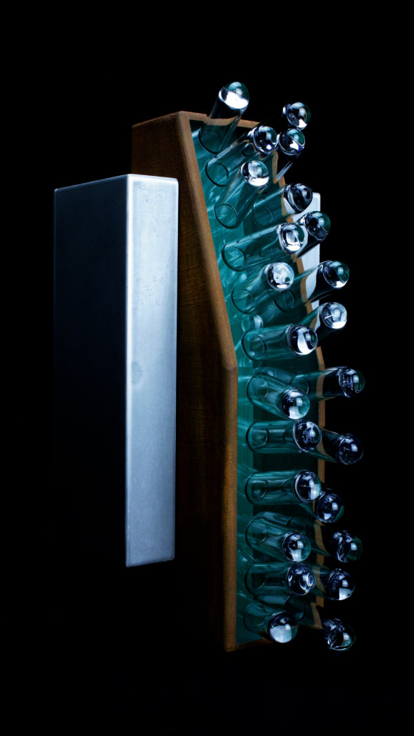 Clear glass tube shapes set in a vertical wooden box as a wall sculpture.