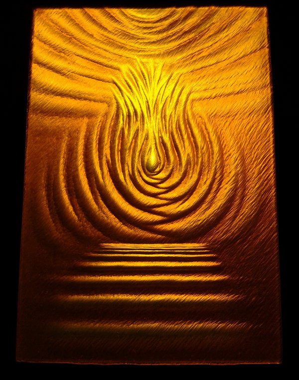 A rich monochrome amber stained glass panel that has been carved with a semi-abstract design resembling steps up to a central flame with swirling curves above and to the sides. The deep carving creates dark shadows.