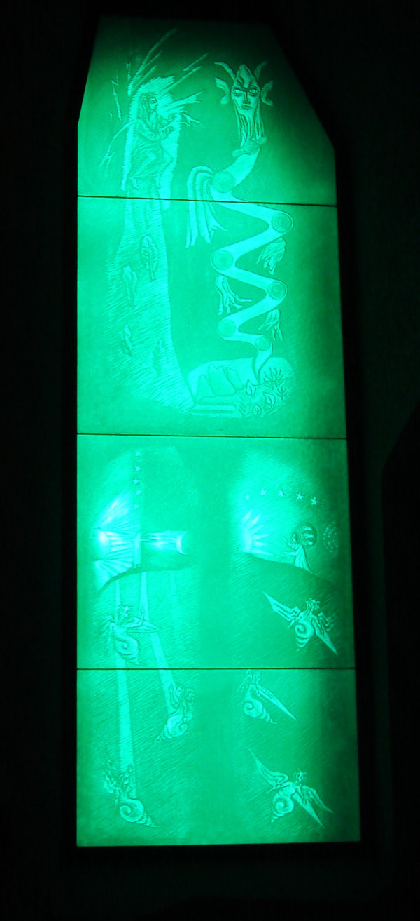 A green carved glass panel at the Goetheanum in Switzerland featuring mystical creatures.