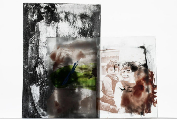 Layered glass picture featuring photographs made using recycled glass.