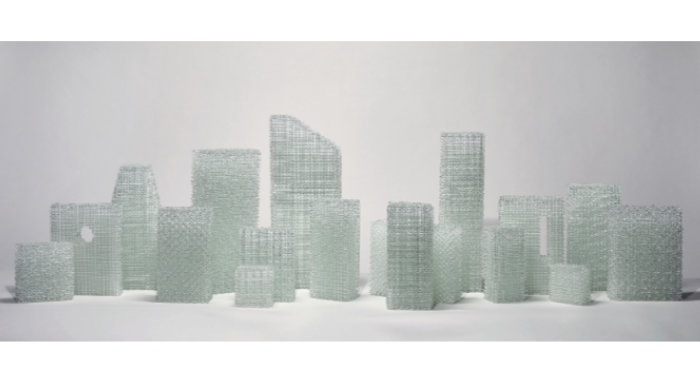 About 16 clear glass rectangles and squares suggestive of a cityscape, called Ghost Town and made by Cathryn Shilling.
